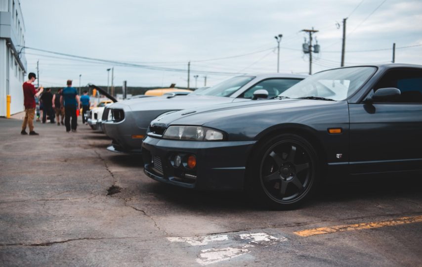 A picture of people shopping outside at a car dealership